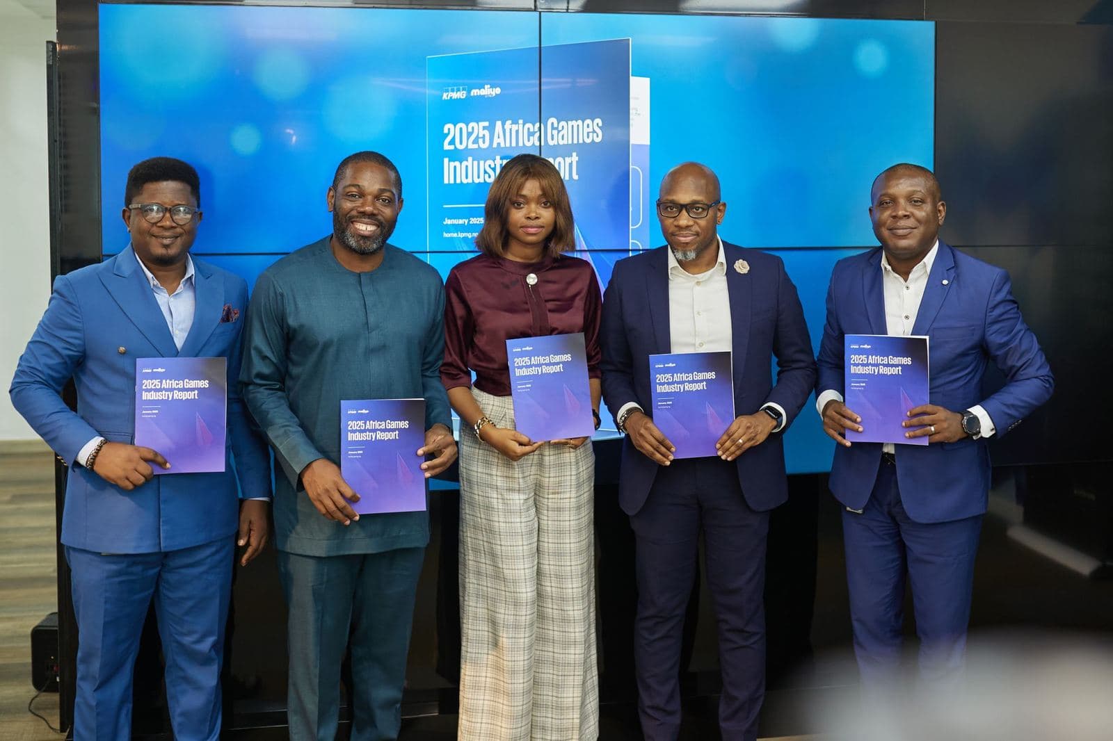 Five industry leaders holding copies of the 2025 Africa Games Industry Report at its launch